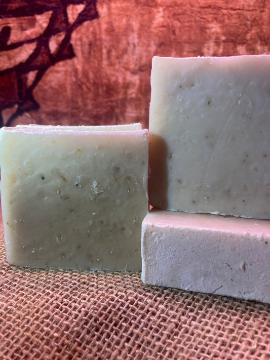Three bars of soap on a textured brown surface