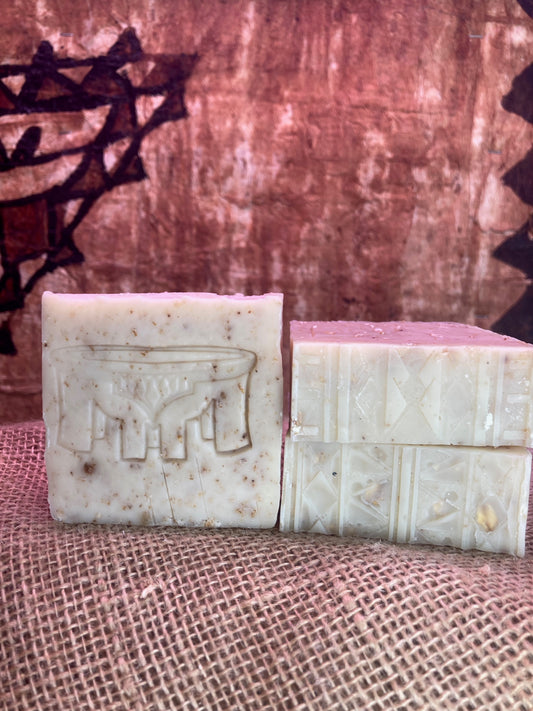 One Soap with Kava Bowl imprint next to Two soap bars with Tatau imprint designs on a textured surface