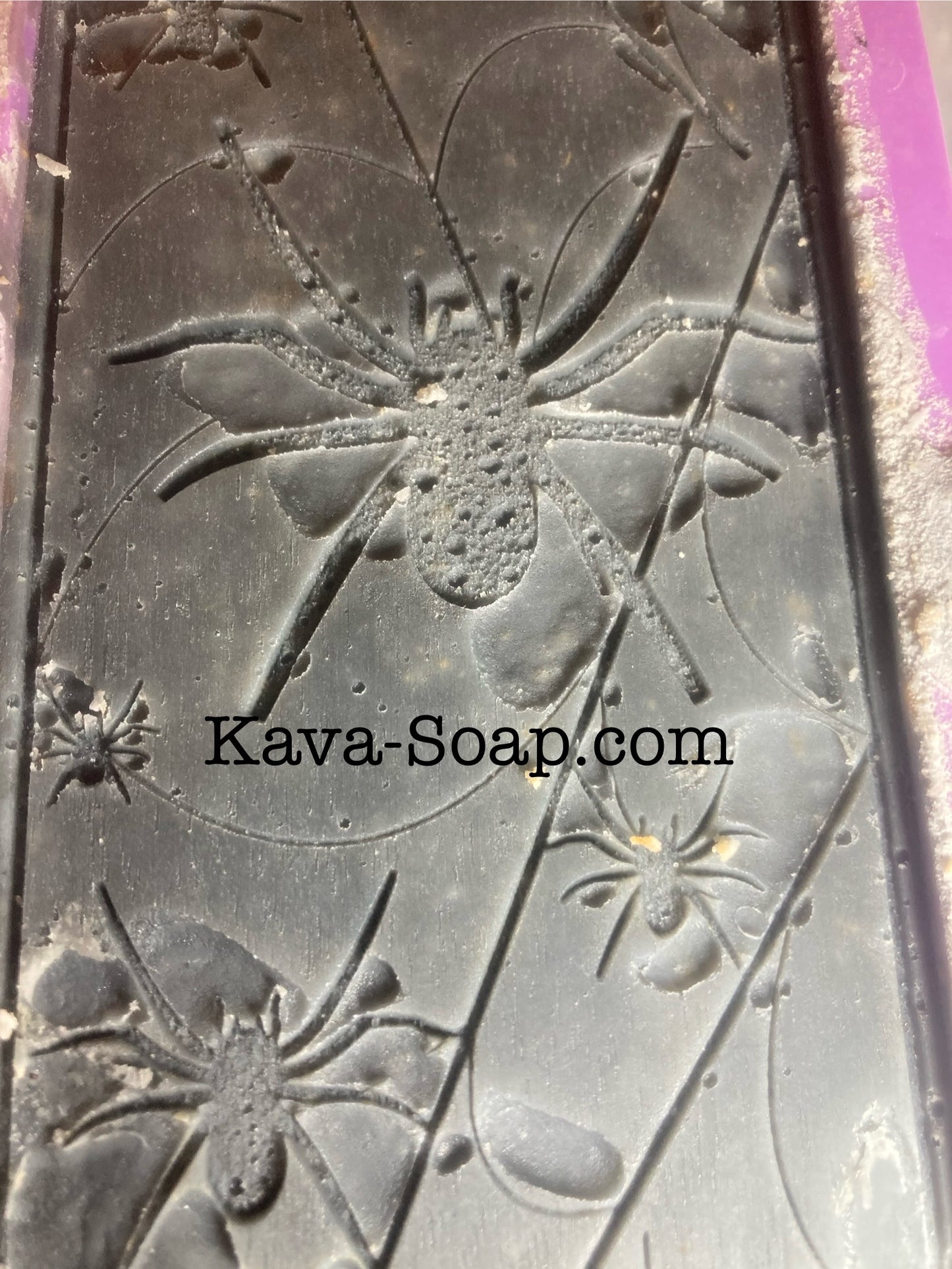 Soap mold with spider design and 'Kava-Soap.com' branding.