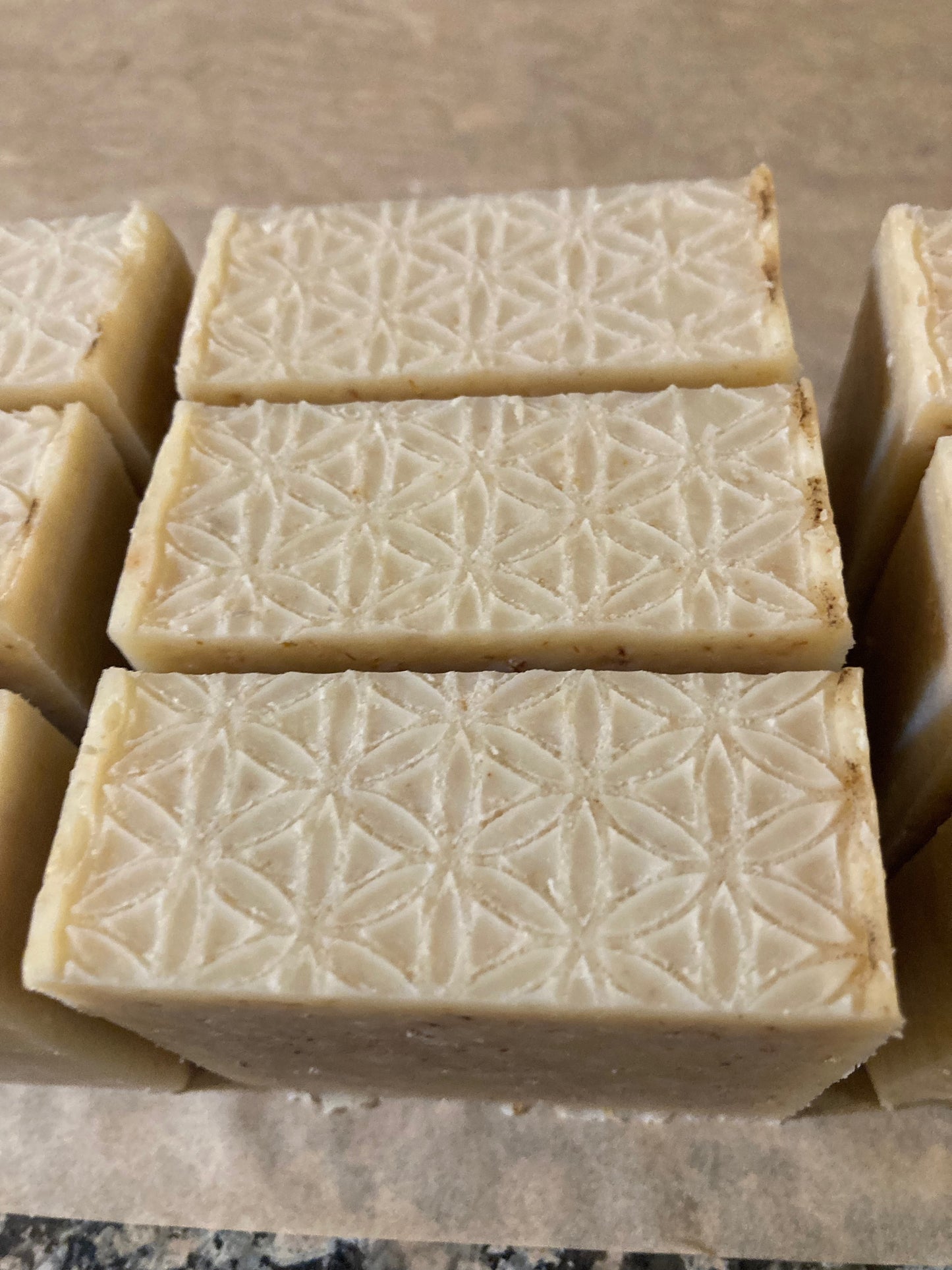 Stack of soap bars with a geometric pattern on a brown surface