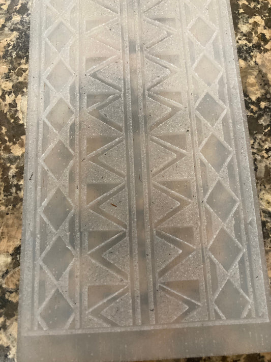 Clear silicone mold with geometric pattern on a marble surface