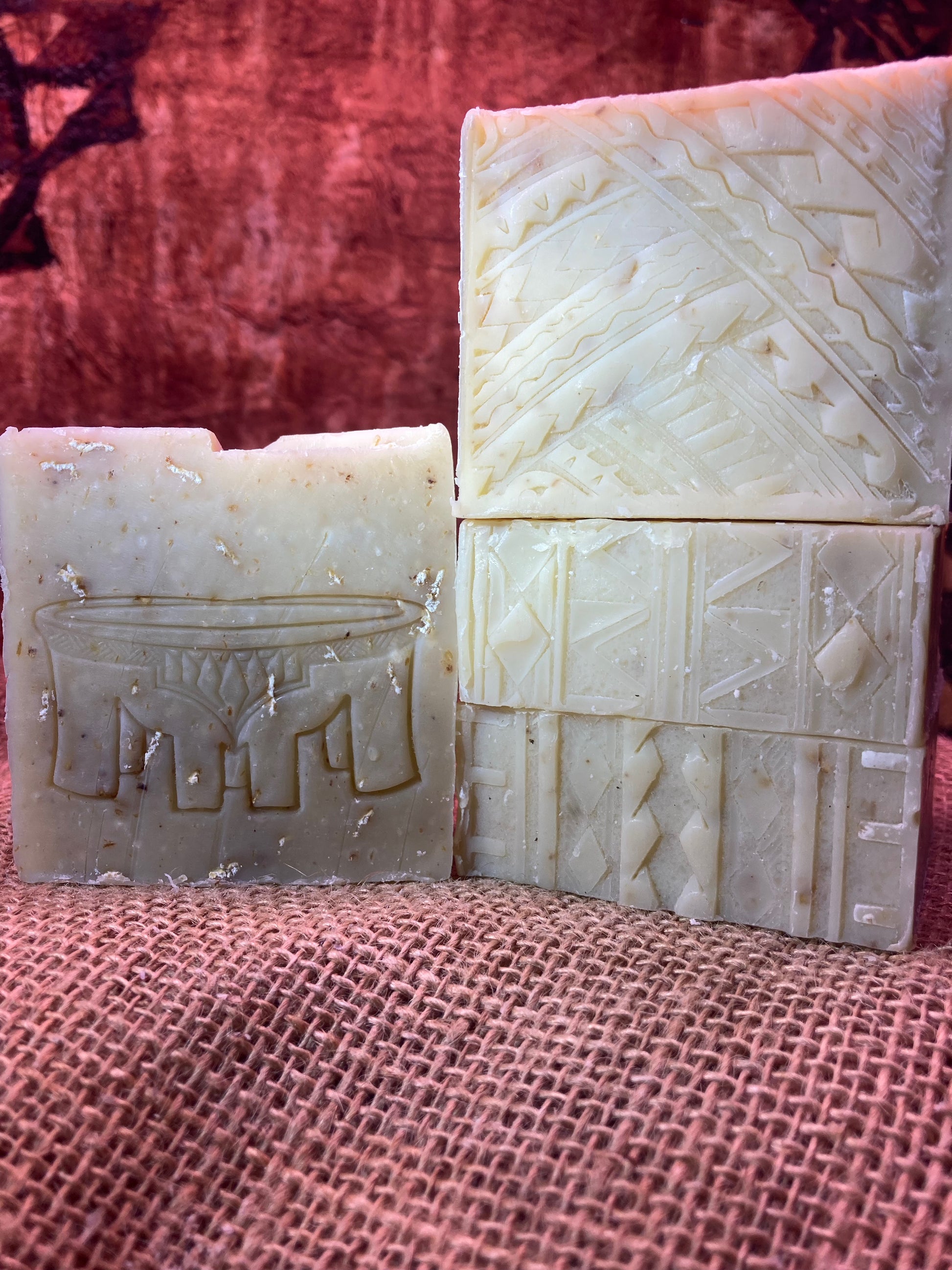 Four bars of soap with textured surfaces on a Burlap Bag