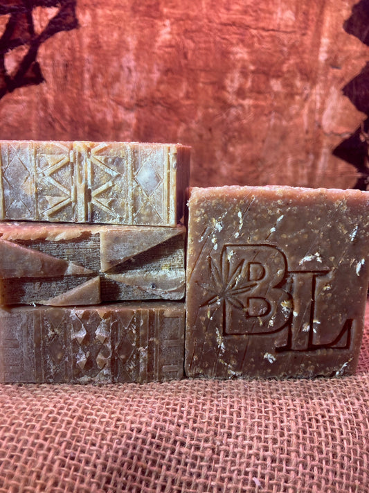 Four bars of soap with textured surfaces on a Burlap Bag