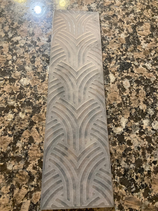 Rectangular silicone mat with a geometric pattern on a granite surface