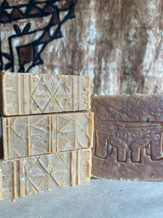 Four bars of soap with textured surfaces on a Burlap Bag
